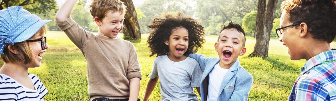 Diverse group of children playing together in nature.