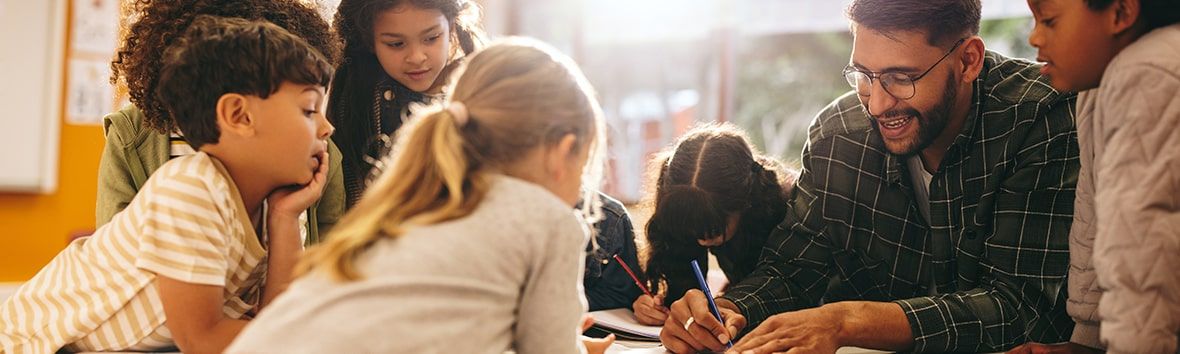 Teacher is demonstrating how to complete an assignment to his students
