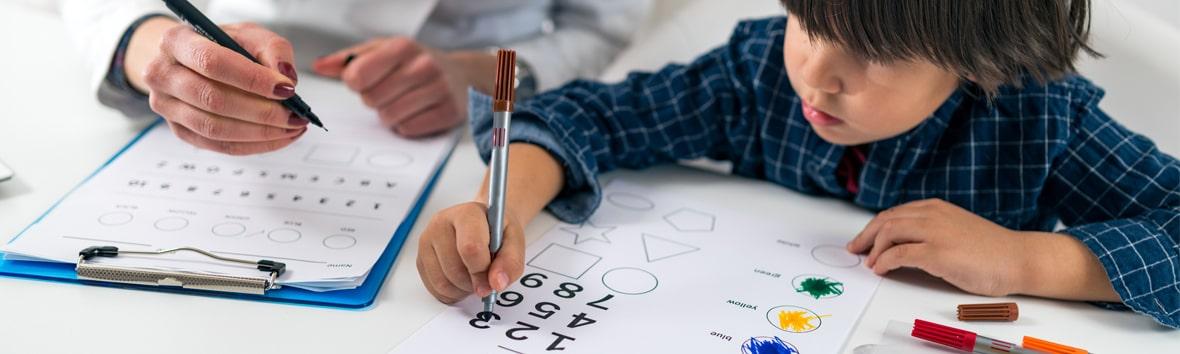Clinician assessing a child's various cognitive abilities through testing.