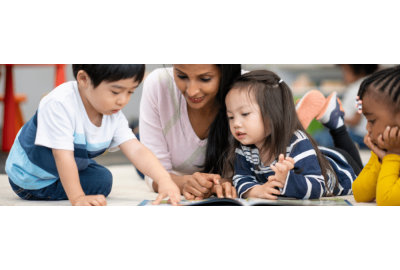 Preschool teacher reading with students