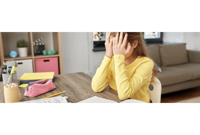 How stress affects learning and reading centers in the brain - a young girl sitting at a desk with her head in her hands