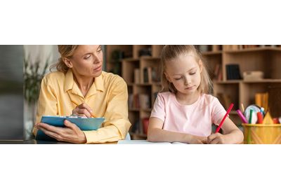 Image of a caring clinician engaging with a young child during an assessment, creating a safe and supportive space.