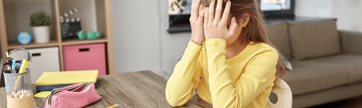 How stress affects learning and reading centers in the brain - a young girl sitting at a desk with her head in her hands