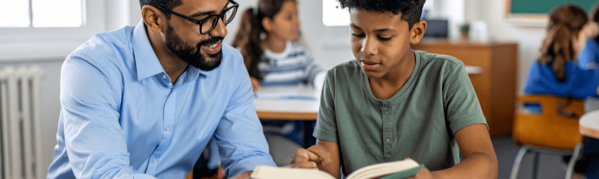 Teacher working one-on-one with a student in a classroom during dyslexia intervention