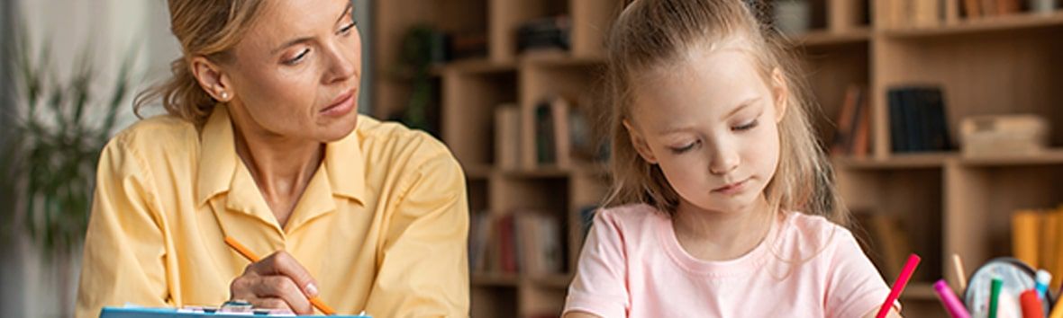 Image of a caring clinician engaging with a young child during an assessment, creating a safe and supportive space.