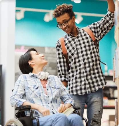 Cheerful student helping disabled student